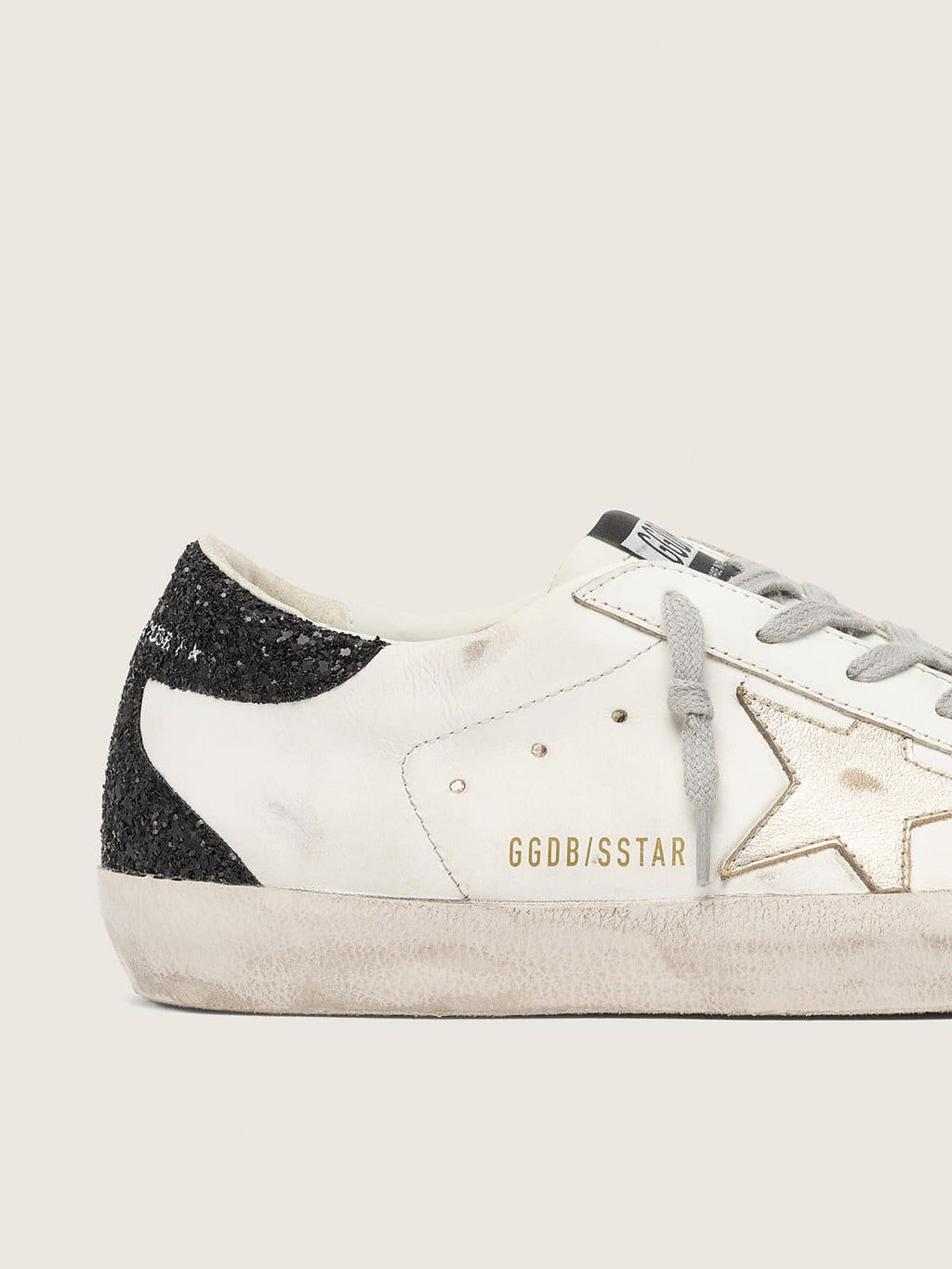 Super-Star avec étoile dorée et contrefort à paillettes noires