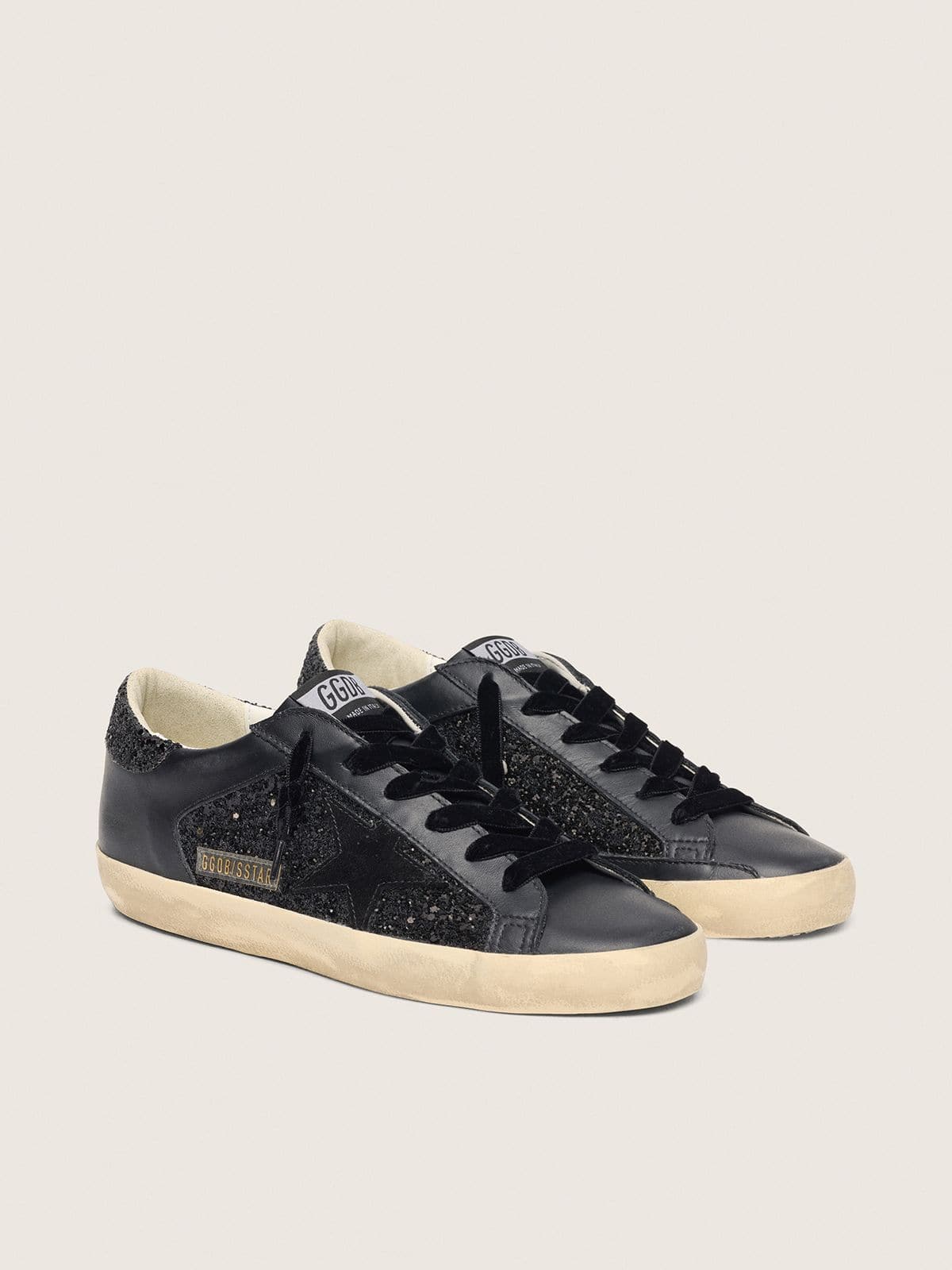 Super-Star pour femme à paillettes noires avec étoile en daim noir et empiècements en cuir