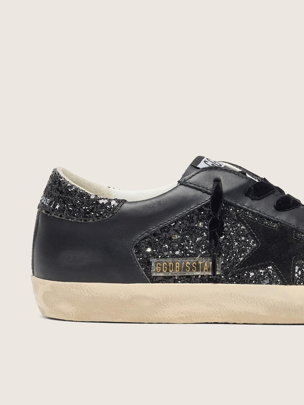 Super-Star pour femme à paillettes noires avec étoile en daim noir et empiècements en cuir